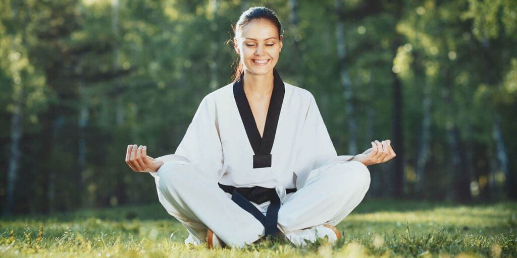 Martial Arts Lessons for Adults in Lake Jackson TX - Happy Woman Meditated Sitting Background